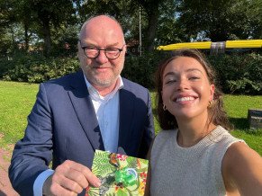 Winnares van loting publieksonderzoek Lotte Brouwer krijgt VVV-bon uitgereikt door interim voorzitter van het bestuur Stijn Terlingen